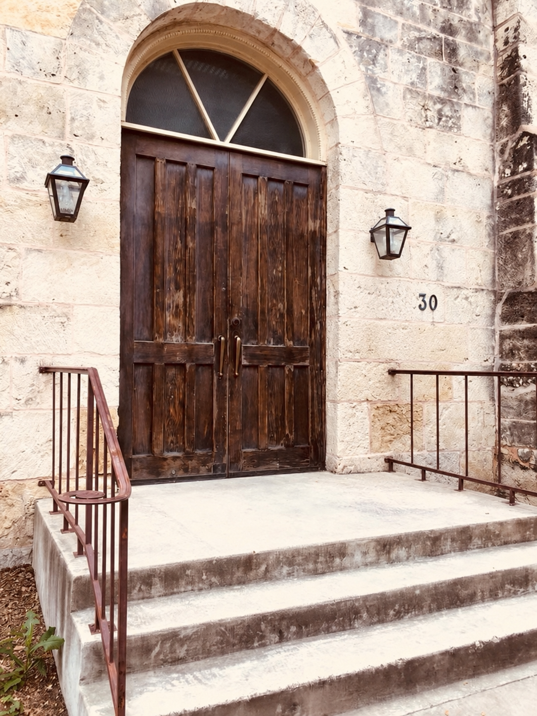 The Spire’s arched wooden entrance and stone steps